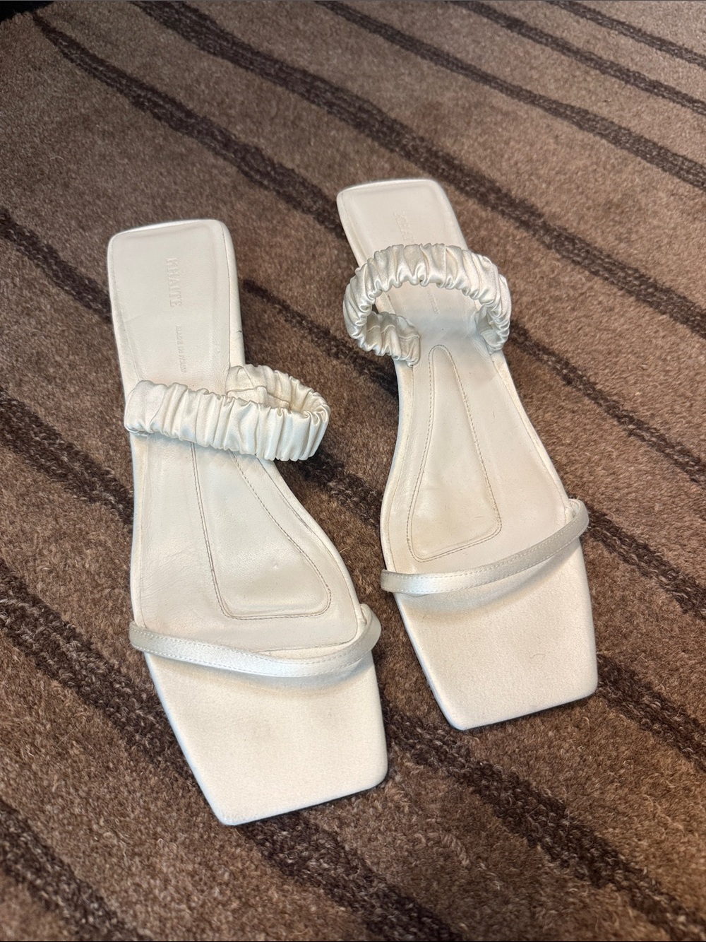 KHAITE White Ruched Double‑Band Slide Sandals